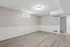 Spacious and bright room with elegant light wood flooring, neutral walls, and abundant natural light perfect for versatile living space.