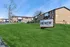 Vibrant apartment complex with lush green lawns and ample parking at ReNew on Blues, offering a welcoming community atmosphere.
