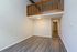 Elegant apartment featuring a spacious loft-style living area with high ceilings and sleek hardwood floors, ideal for modern living.