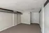 Inviting apartment room with modern exposed ductwork and plush carpet, ready for personal design touches.