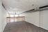 Expansive loft space with plush carpeting and modern exposed ductwork, ideal for a cozy living area or creative workspace.