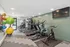 Modern fitness center featuring treadmills, stationary bike, and colorful exercise balls in a bright, spacious room.