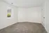 Bright and cozy unfurnished room with plush carpeting and a large window offering natural light.