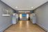 Modern apartment lobby with sleek gray walls, light wooden flooring, and welcoming signage at Renew Taunton on Highland.
