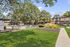 Charming apartment complex with lush green landscaping, a sparkling outdoor pool, and inviting patio area perfect for relaxation.