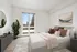 Inviting bedroom with chic decor, large window view, and stylish furniture, accentuated by natural light.