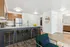 Modern kitchen with sleek cabinetry, shining stainless steel appliances, and a stylish breakfast bar adorned with elegant bar stools.