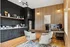 Modern home office with sleek black cabinetry, wooden wall accents, stylish decor, and cozy seating.