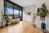 Bright, modern entryway with large windows, elegant decor, and lush indoor plants, perfect for welcoming guests.