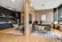 Modern co-working space with chic wood-panel walls, sleek furniture, and abundant natural light, perfect for productivity and collaboration.