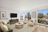 Bright and inviting living room with stylish decor, modern furniture, and large windows showcasing scenic views.