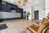 Modern apartment lobby with stylish wicker lighting, comfortable leather seating, inviting decor, and a functional mail system.