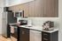 Modern kitchen with stainless steel appliances, sleek cabinetry, and elegant marble countertops, perfect for culinary enthusiasts.