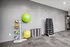 Modern fitness room equipped with vibrant exercise balls, dumbbells, and yoga mats for a complete workout experience.