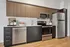 Modern kitchen with sleek stainless steel appliances, elegant wooden cabinets, and stylish hardwood flooring for a contemporary living space.