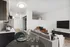 Modern open-concept living area with stylish kitchen, cozy seating, and sleek decor.