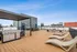 Stunning rooftop terrace with modern grill station, elegant seating, and panoramic sky views, perfect for outdoor entertainment.