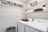 Chic laundry room with modern appliances, stylish storage baskets, and organized shelving for a seamless cleaning experience.