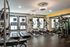 Modern fitness center equipped with state-of-the-art treadmills, ellipticals, and strength training machines in a well-lit environment.