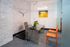 Chic modern office space with sleek glass desk, vibrant orange chairs, and contemporary art, creating an inviting and stylish ambiance.