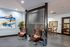 Modern and inviting lobby with stylish leather chairs, abstract artwork, and elegant decor accents.