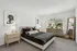 Modern bedroom with chic decor, featuring a plush bed, elegant artwork, and a large window flooding the space with natural light.