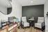 Cozy seating area with modern chairs and a sleek coffee station in a stylish room.