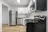 Modern kitchen with sleek stainless steel appliances, elegant white cabinetry, and stylish marble countertops.