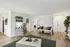 Elegant living room featuring stylish decor, plush seating, a chic coffee table, and abundant natural light, perfect for relaxation and entertaining.