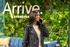 Chic modern lobby with lush green wall, blue sofa, and welcoming atmosphere at Arrive Streeterville.