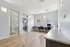 Bright and modern workspace with sleek design, featuring expansive windows, minimalist desks, and elegant lighting.