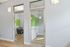 Modern study rooms with sleek glass doors and vibrant green accent wall, ideal for focused work.