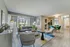 Bright, modern living space with elegant seating, floor-to-ceiling windows, and a cozy dining area, perfect for contemporary living.