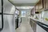 Modern galley kitchen with sleek stainless steel appliances, elegant wooden cabinets, and chic subway tile backsplash.