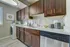 Elegant kitchen with rich wooden cabinets, modern backsplash, and built-in appliances, offering a blend of style and functionality.