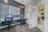 Modern home office with sleek workstations, comfortable chairs, and ambient lighting, seamlessly connected to a bright and inviting living space with stylish decor.