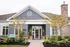 Charming leasing center exterior with elegant landscaping and inviting entrance.