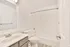 Modern bathroom with sleek fixtures, a spacious bathtub, and elegant tile accents.