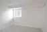 Bright and inviting empty room with soft carpet flooring, large window for natural light, and classic white walls offering a blank canvas for your personal touch.