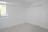 Bright and airy bedroom with plush carpeting, large window offering natural light, and spacious white closet doors.