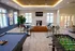 Chic community lounge featuring a cozy fireplace, stylish seating, and games like pool and foosball, perfect for relaxation and socializing.