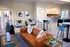 Elegant apartment lounge featuring contemporary decor, stylish seating, a modern open kitchen, and a foosball table.