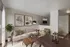 Chic living room with warm tones, featuring modern artwork, a cozy sofa, and elegant floor lamp, perfect for relaxation.
