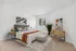 Elegant bedroom with plush carpeting, modern decor, stylish bed, and large windows inviting ample natural light.