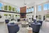 Bright and spacious lounge area with elegant seating arrangements, modern decor, and large windows showcasing a scenic outdoor view.
