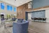 Elegant community lounge with modern blue armchairs, high ceilings, and expansive windows offering a bright, inviting atmosphere.