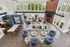 Spacious and inviting living area with modern design featuring ample seating, a cozy fireplace, high ceilings with large windows, and an open concept kitchen.