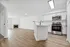 Modern open-concept living space featuring sleek hardwood floors, a cozy fireplace, and a contemporary kitchen with stainless steel appliances.