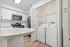 Modern kitchen with stainless steel appliances and in-unit washer and dryer for convenience.