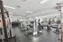 Bright and modern fitness center with state-of-the-art exercise equipment and large windows for natural light.